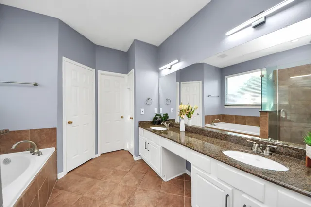 a view of an empty room with closet and bathroom