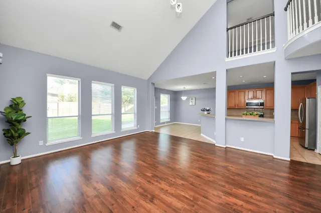 wooden floor in an empty room with a window and wooden floor