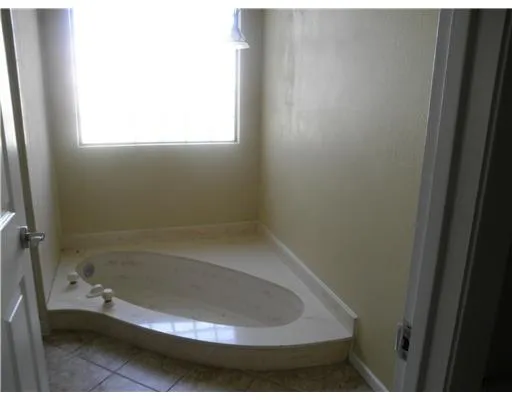 a bathroom with a bathtub and a window