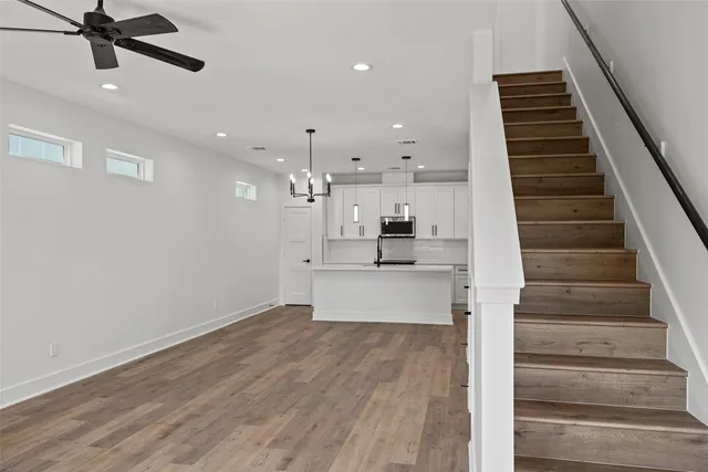 an empty room with a window and a ceiling fan