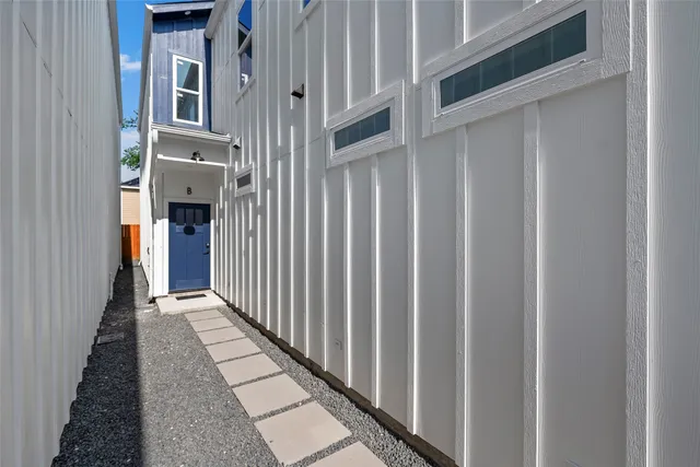 a living room with furniture a rug and a clock