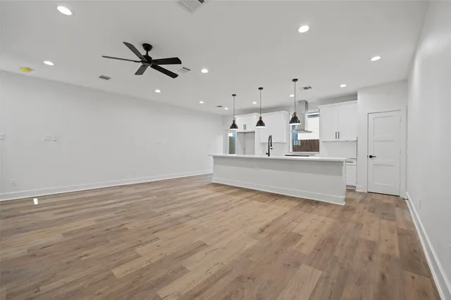 a kitchen with stainless steel appliances a microwave a sink a stove and a refrigerator