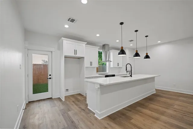a view of a backyard with potted plants and wooden fence