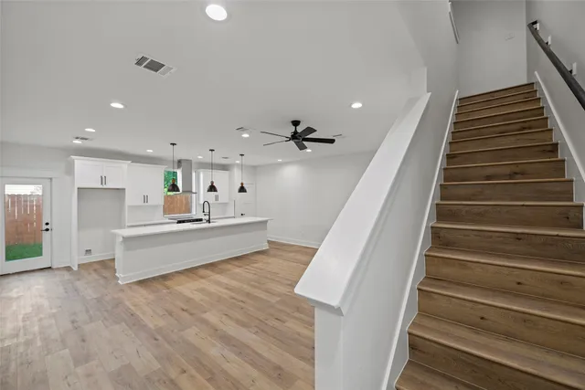 an empty room with a window and a fan