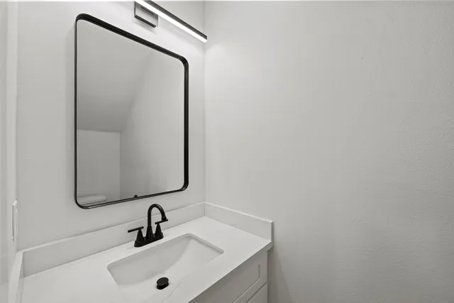 a view of a kitchen with a sink and wooden floor