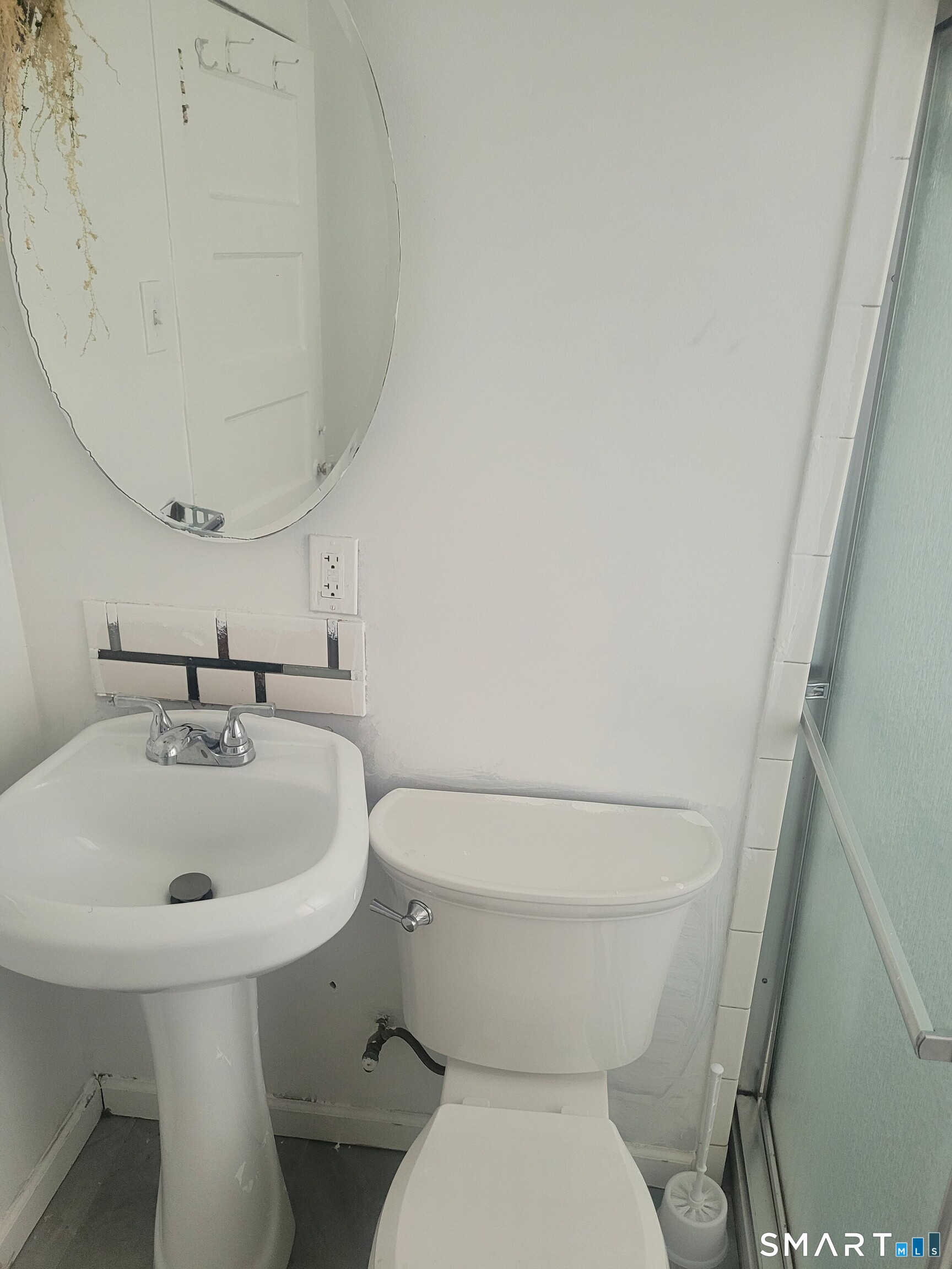 606 Wilmot Avenue, Unit 4 Bridgeport, CT 06607 - Photo 10 of 16 a white toilet sitting next to a bathroom sink