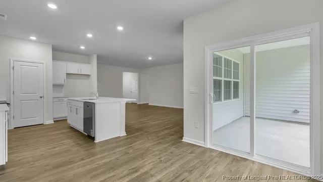 a view of kitchen with wooden floor and electronic appliances