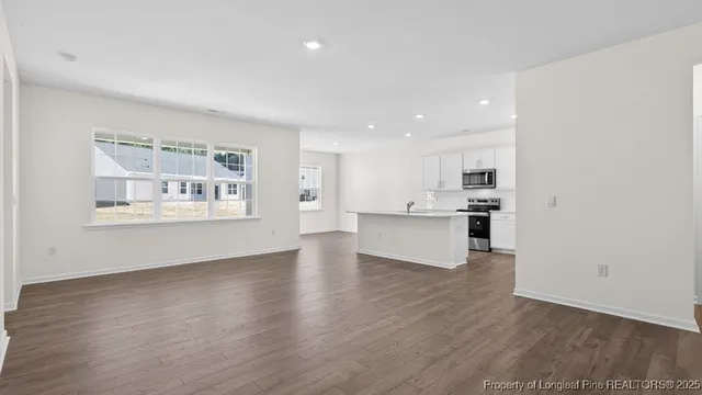 a view of kitchen with wooden floor and windows
