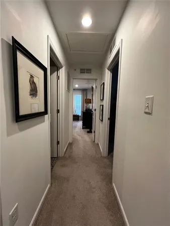 a view of a hallway with paintings on the wall