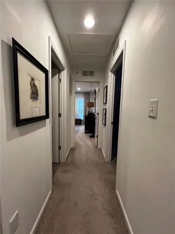 a view of a hallway with paintings on the wall