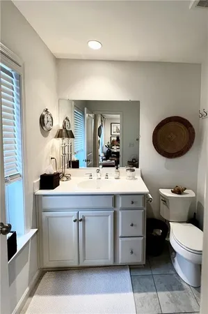 a view of bathroom with a toilet sink and mirror