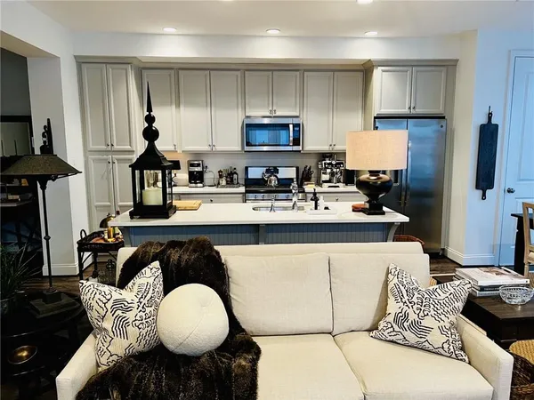 a kitchen with stainless steel appliances granite countertop a stove a sink and a refrigerator