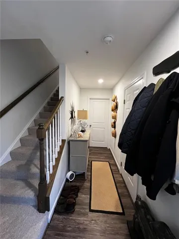 a view of entryway and hall with wooden floor