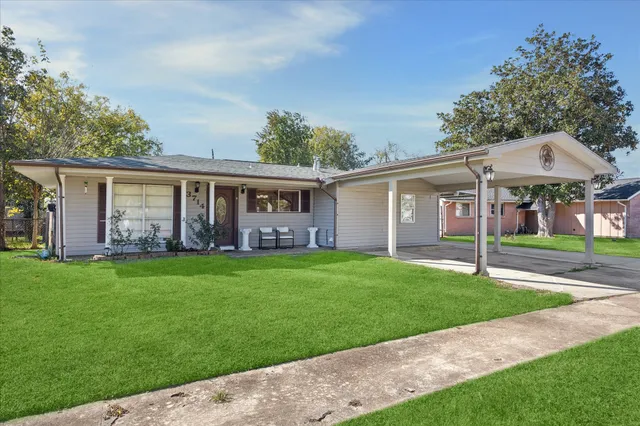 a view of a house with a yard and a garden