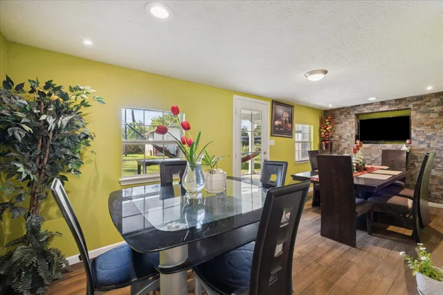 a view of a dining room with furniture window and wooden floor
