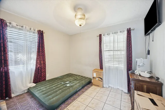 a view of room with window and a ceiling fan