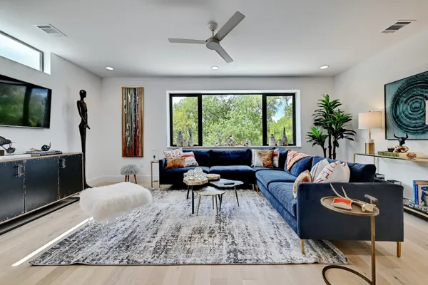 a living room with furniture a large window with outer view