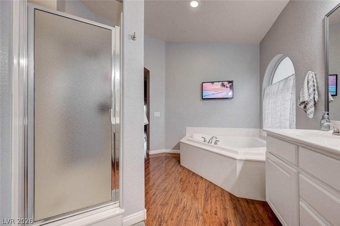 1604 Cattle Ranch Place Henderson, NV 89002 - Photo 42 of 99 Luxurious soaking tub and separate shower await in this well-appointed bathroom.