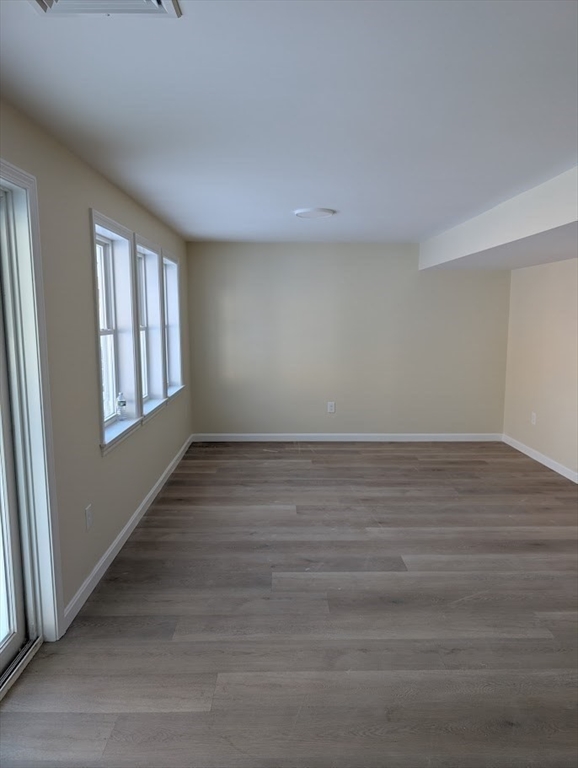778 Main Street, Unit 6 Leicester, MA 01524 - Photo 16 of 39 a view of an empty room with wooden floor and window