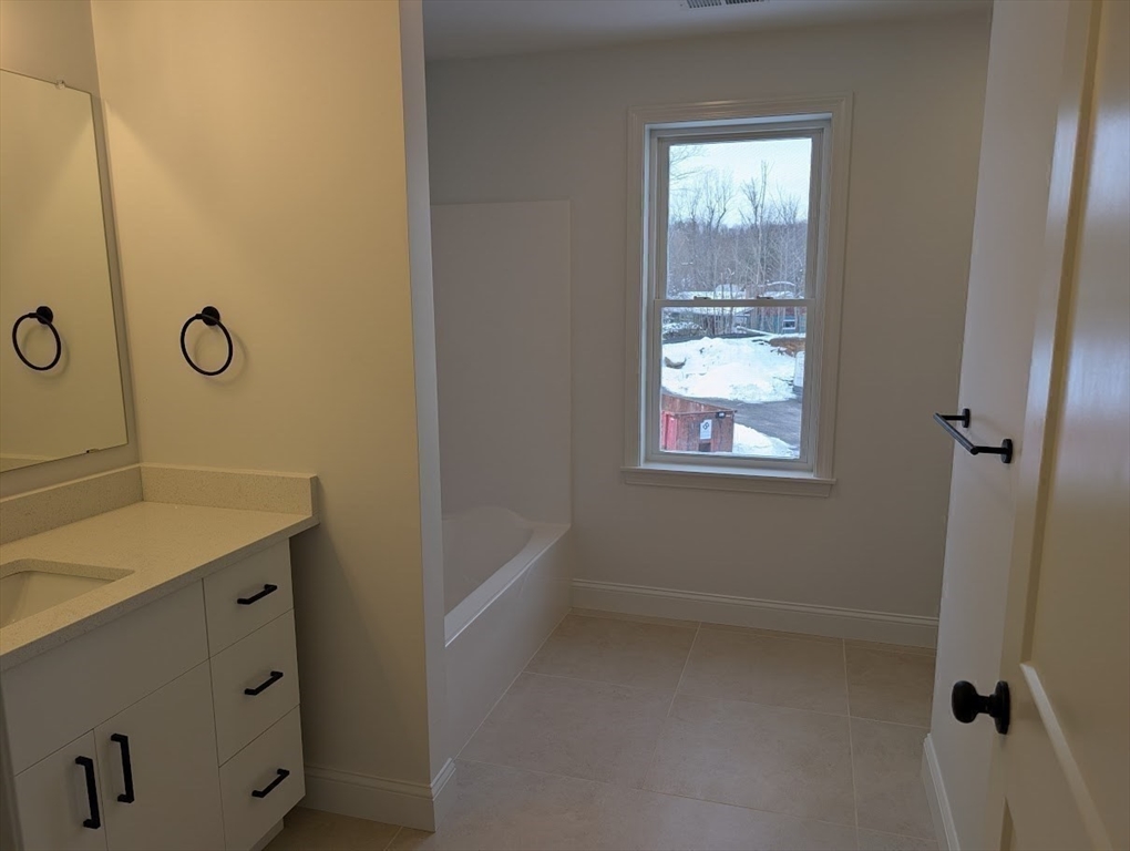 778 Main Street, Unit 6 Leicester, MA 01524 - Photo 21 of 39 a bathroom with a sink and a mirror