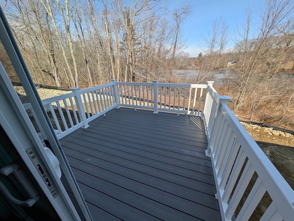 778 Main Street, Unit 6 Leicester, MA 01524 - Photo 34 of 39 a balcony with wooden floor and fence