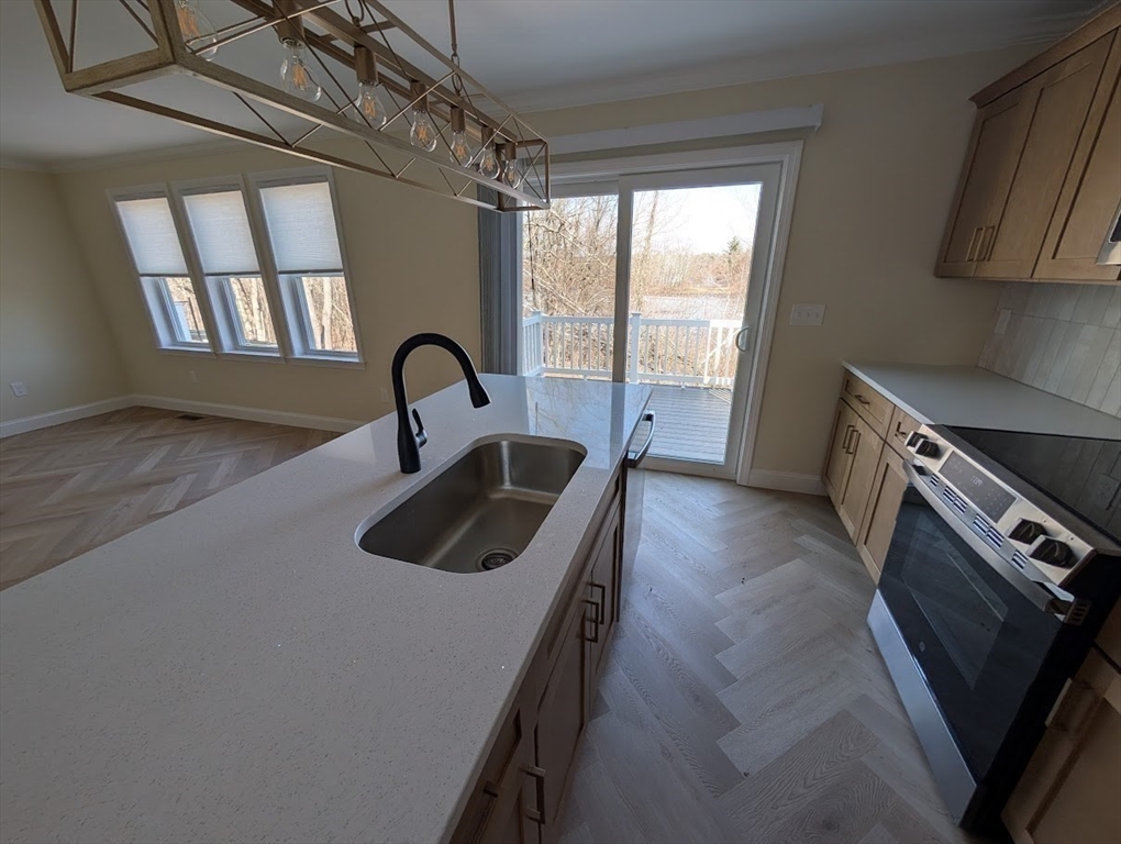 778 Main Street, Unit 6 Leicester, MA 01524 - Photo 6 of 39 a kitchen with a sink a counter top space and stainless steel appliances