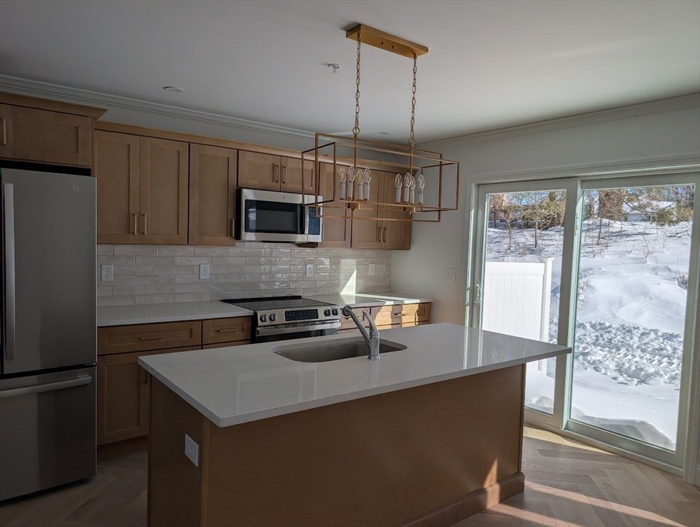 778 Main Street, Unit 6 Leicester, MA 01524 - Photo 7 of 39 a kitchen that has a microwave a sink and a refrigerator
