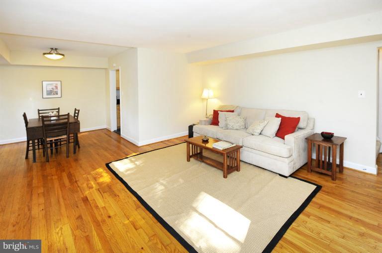 8508 Bradford Road, Unit 75 Silver Spring, MD 20901 - Photo 3 of 13 a living room with dining room and wooden floor