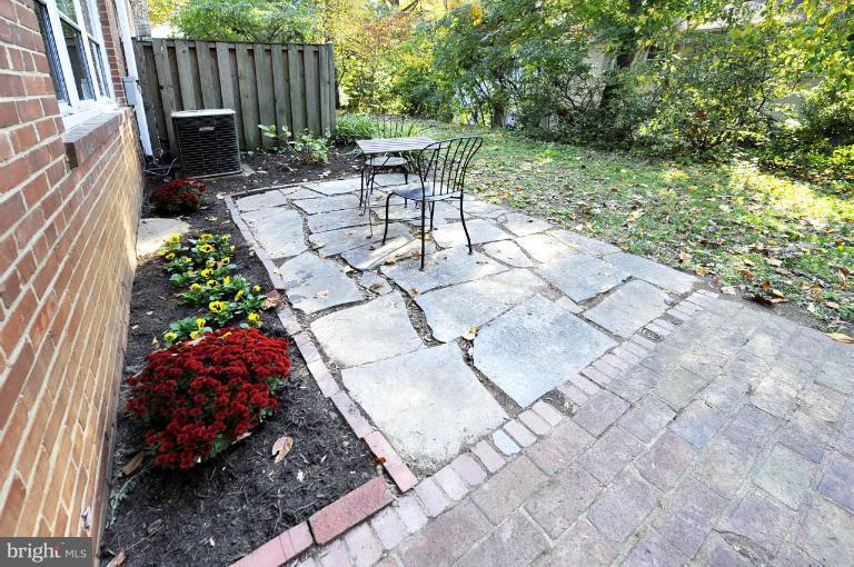 8508 Bradford Road, Unit 75 Silver Spring, MD 20901 - Photo 8 of 13 a view of backyard with a garden and chairs