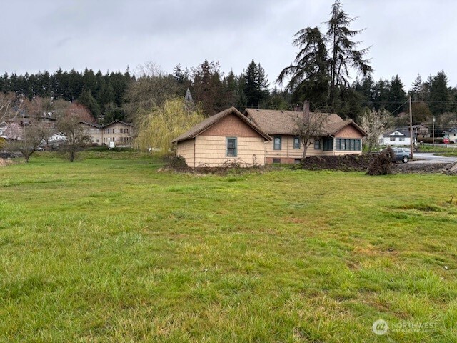 1887 South Market Boulevard Chehalis, WA 98532 - Photo 3 of 16 a view of a town with large trees and a barn in the background
