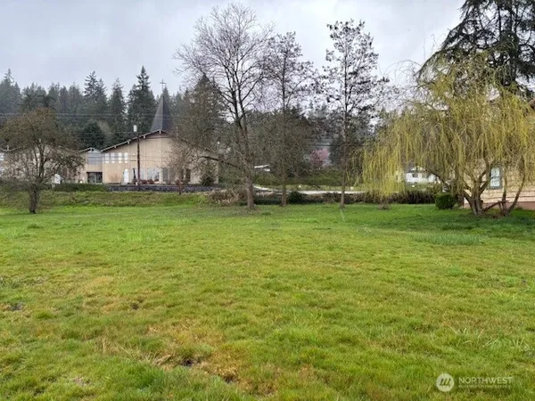 a view of a field of grass and trees