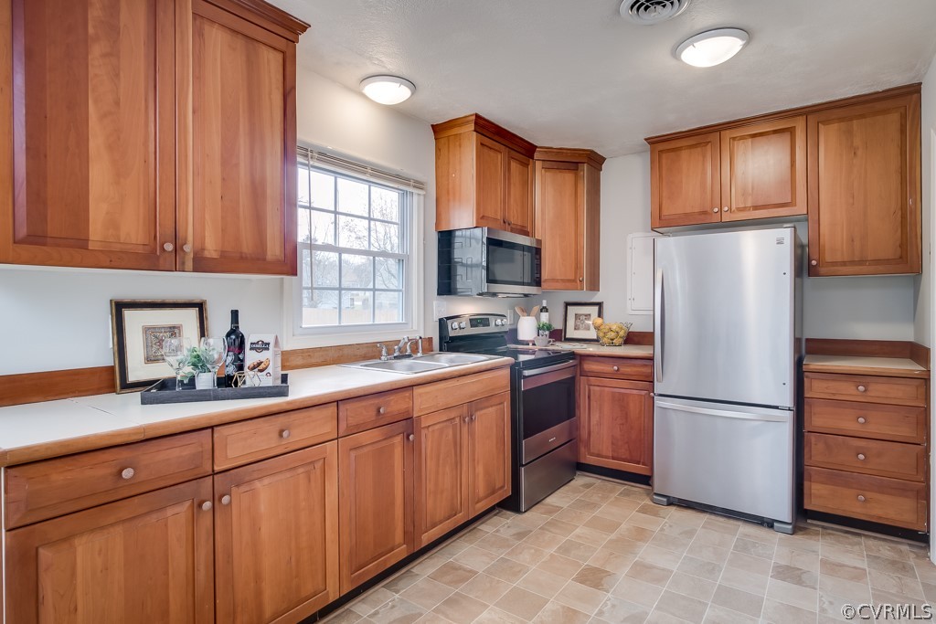 4705 Twelveoaks Road Midlothian, VA 23112 - Photo 9 of 25 a kitchen with stainless steel appliances granite countertop a refrigerator stove top oven and sink