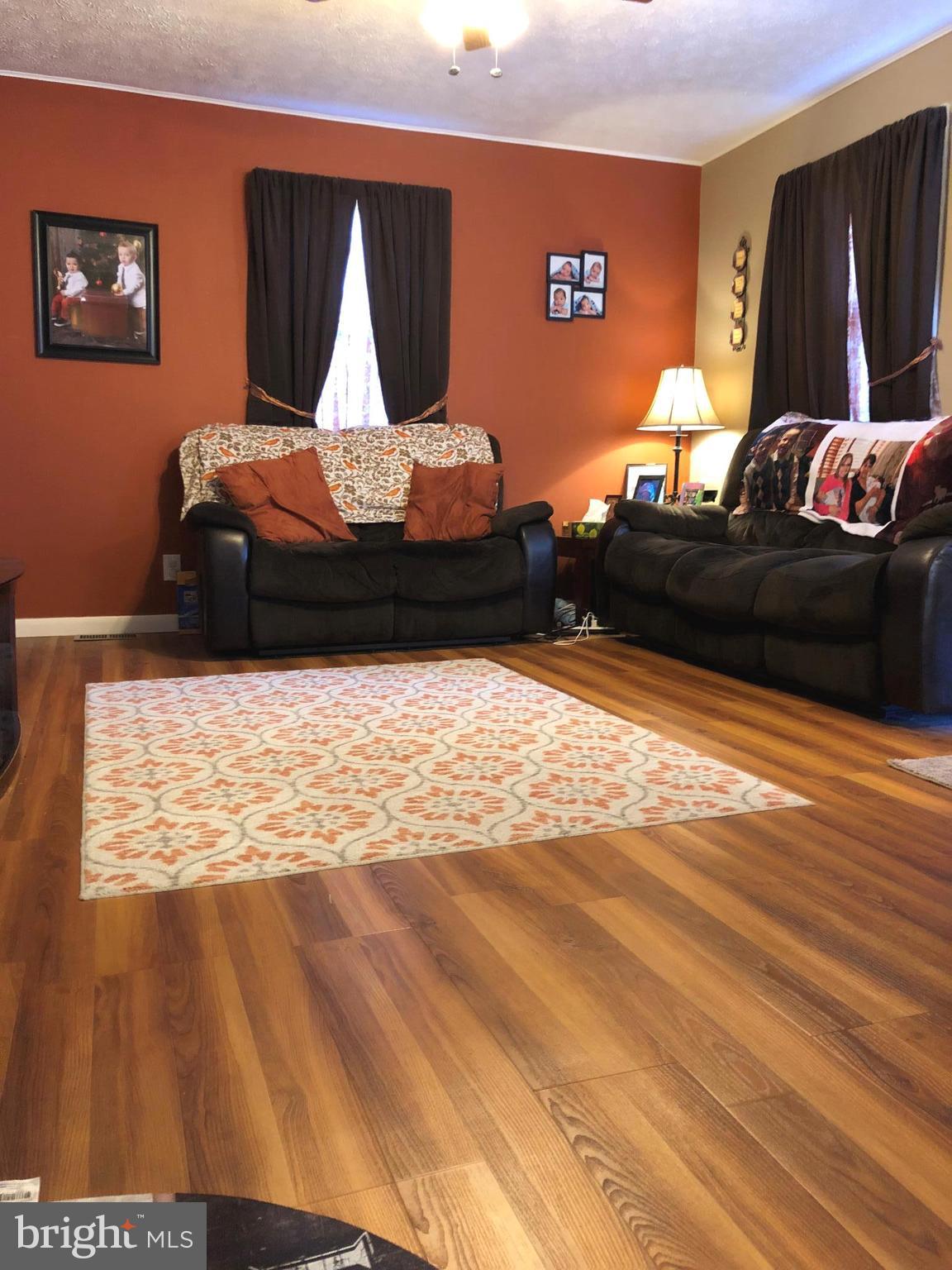 2416 Meadow Road Baltimore, MD 21222 - Photo 12 of 22 a living room with furniture and a wooden floor