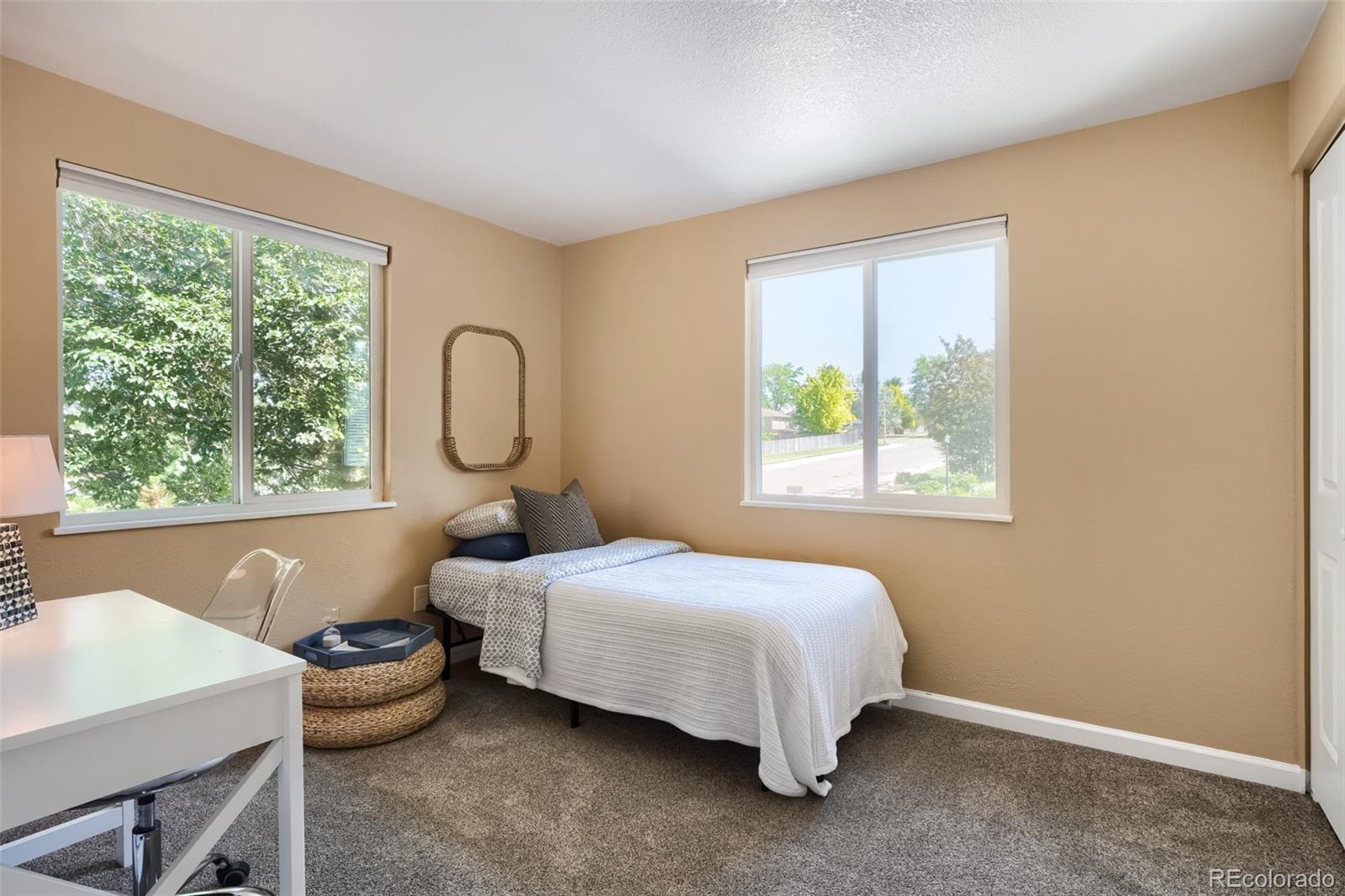 6551 South Albion Way Littleton, CO 80121 - Photo 19 of 37 a bed sitting in a bedroom next to a window