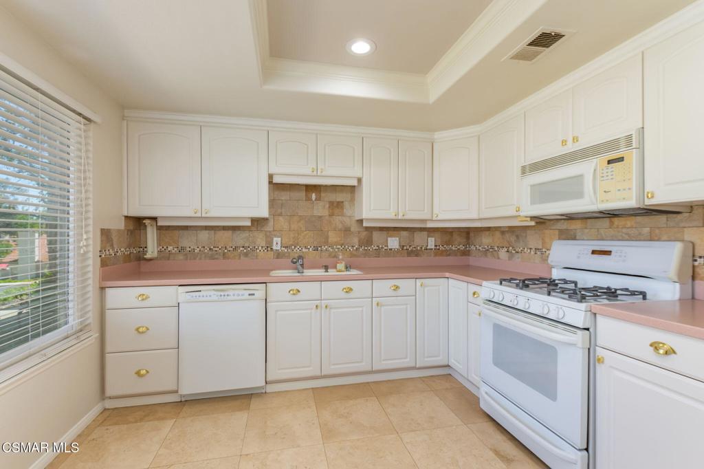 1047 Windmill Lane Oak Park, CA 91377 - Photo 5 of 13 a kitchen with granite countertop a sink stainless steel appliances and cabinets