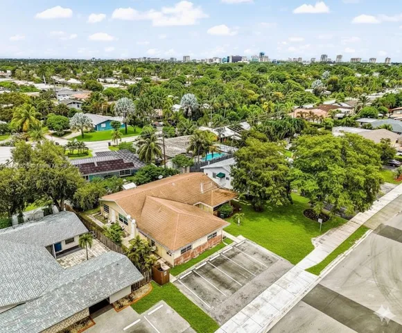 a kitchen with refrigerator and white cabinets