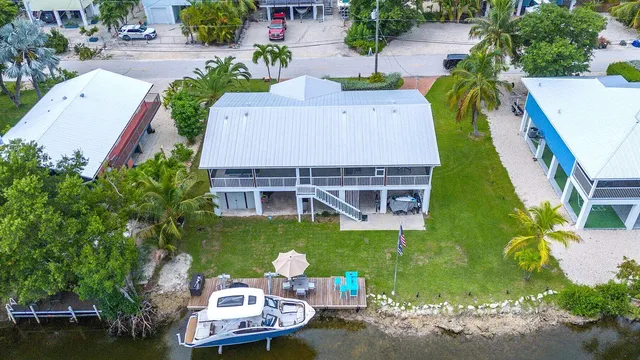 an aerial view of a house with outdoor space pool patio swimming pool and outdoor seating
