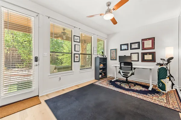 a view of a livingroom with workspace and a window