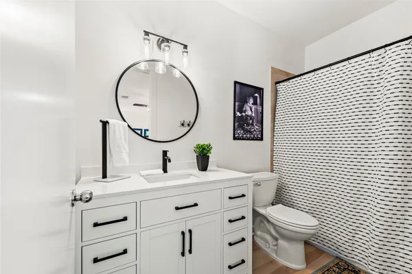 a bathroom with a toilet a sink and a mirror