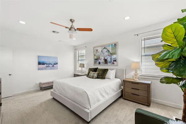 a bedroom with a bed and a painting on the wall
