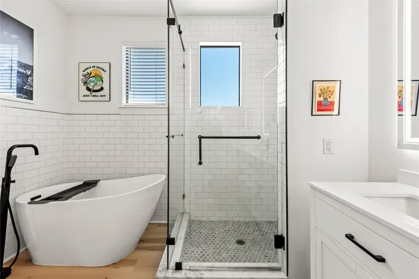 a bathroom with a bathtub and a shower