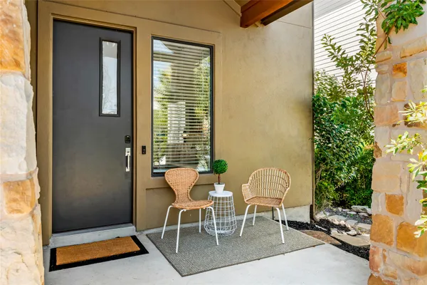 a dining room with furniture and a potted plant