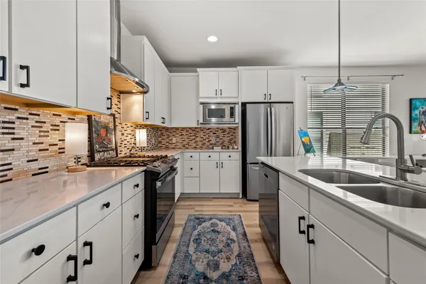 a kitchen with cabinets and stainless steel appliances