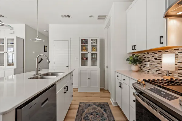 a kitchen with granite countertop a stove and a sink