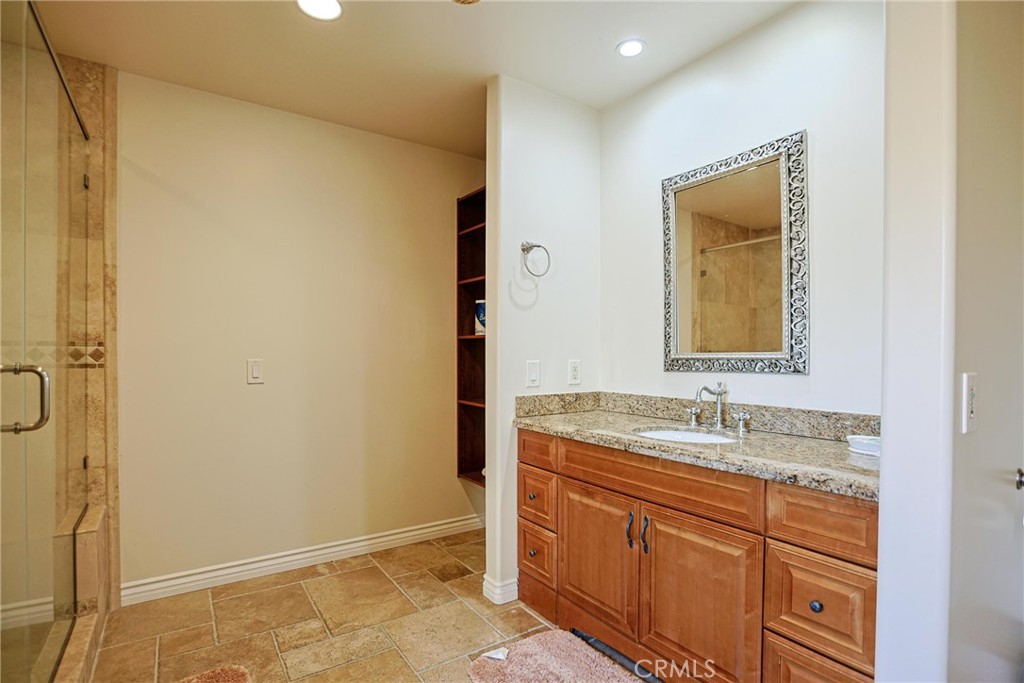 116 Termino Avenue Long Beach, CA 90803 - Photo 18 of 51 a bathroom with a granite countertop sink and a mirror