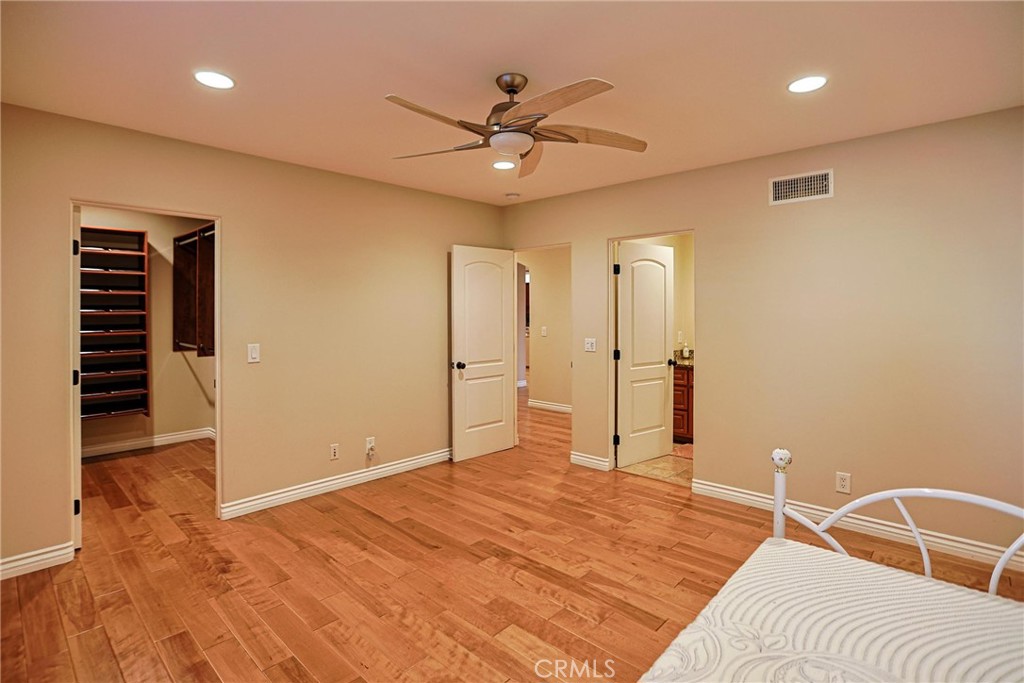116 Termino Avenue Long Beach, CA 90803 - Photo 22 of 51 a bedroom with a bed and a chandelier