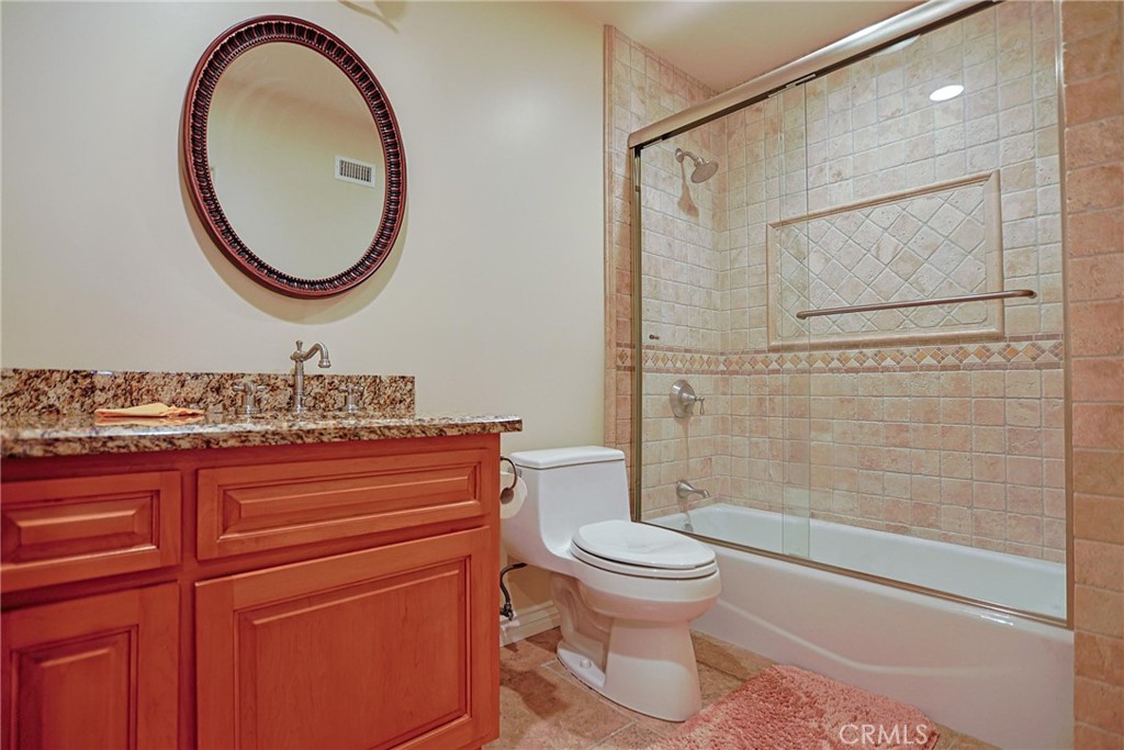 116 Termino Avenue Long Beach, CA 90803 - Photo 24 of 51 a bathroom with a sink a toilet and a mirror
