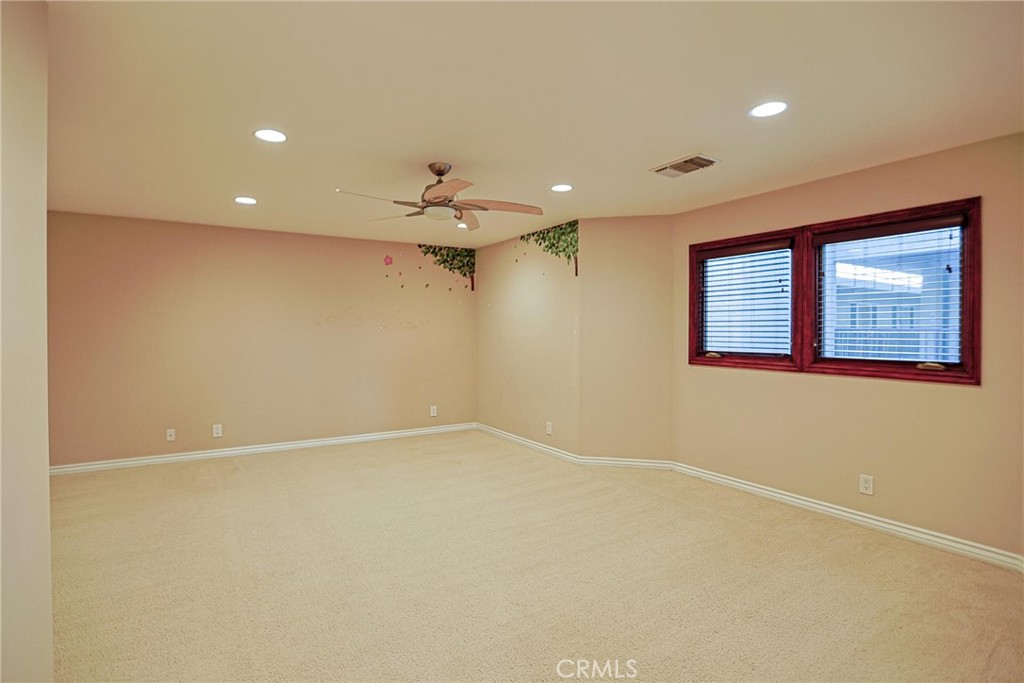 116 Termino Avenue Long Beach, CA 90803 - Photo 27 of 51 an empty room with a chandelier fan and windows
