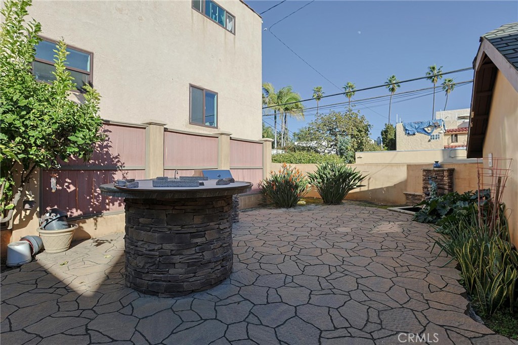 116 Termino Avenue Long Beach, CA 90803 - Photo 42 of 51 a view of a yard with plants and a barbeque