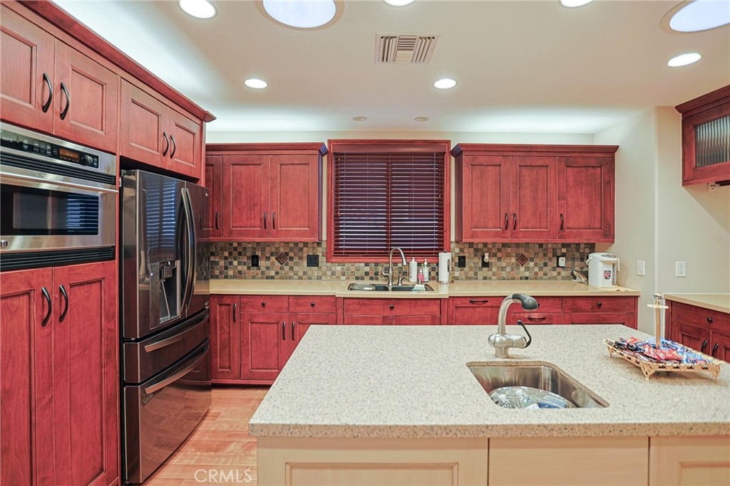 116 Termino Avenue Long Beach, CA 90803 - Photo 7 of 51 a kitchen with kitchen island granite countertop a sink stainless steel appliances and cabinets